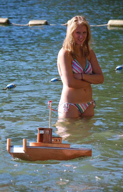 rc tug and girl remote controlled from shore